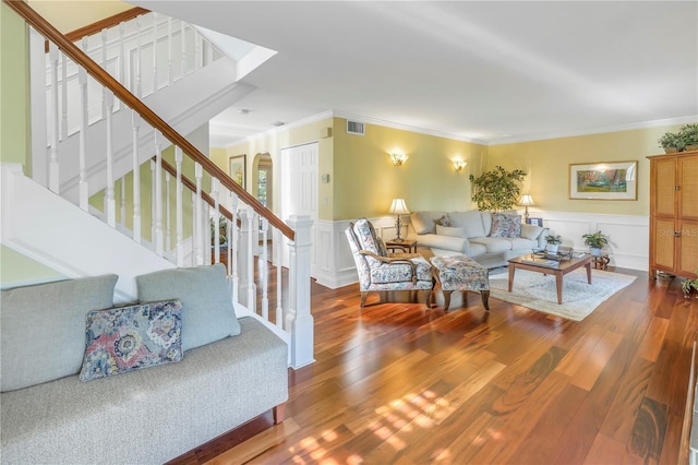 living room with hardwood / wood-style flooring and ornamental molding