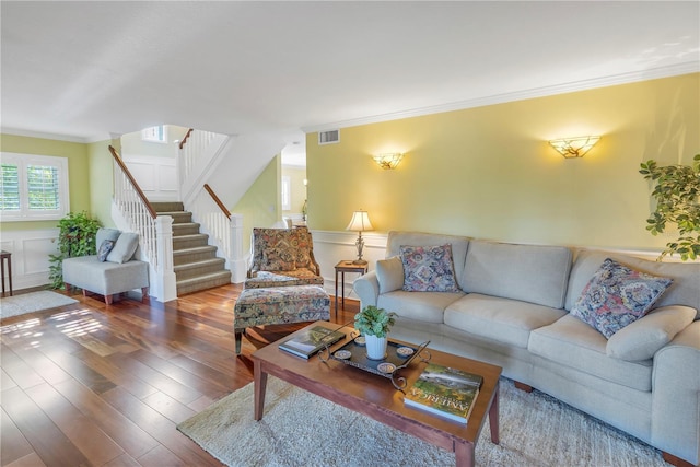 living room with crown molding and hardwood / wood-style flooring