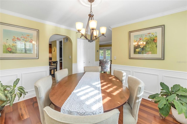 dining space with a chandelier, hardwood / wood-style flooring, and crown molding