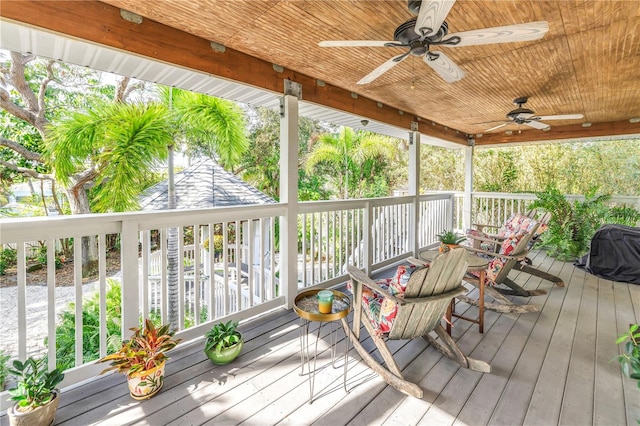 wooden deck featuring ceiling fan