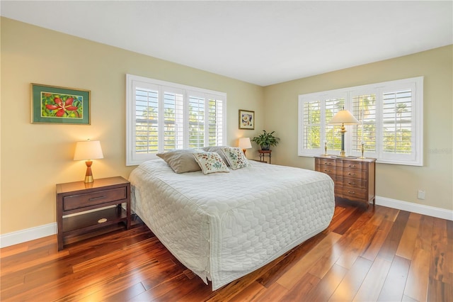 bedroom with dark hardwood / wood-style flooring