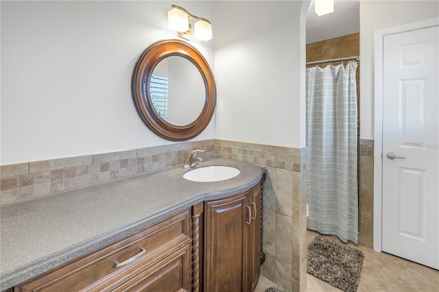 bathroom featuring tile patterned floors, vanity, tile walls, and walk in shower