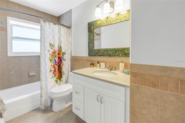 full bathroom with tile patterned flooring, vanity, toilet, and tile walls