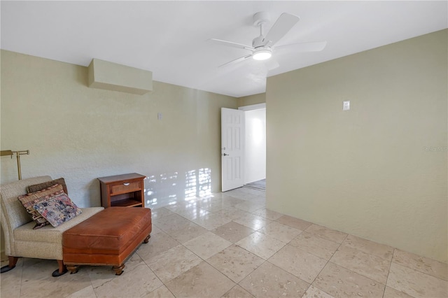 living area with ceiling fan