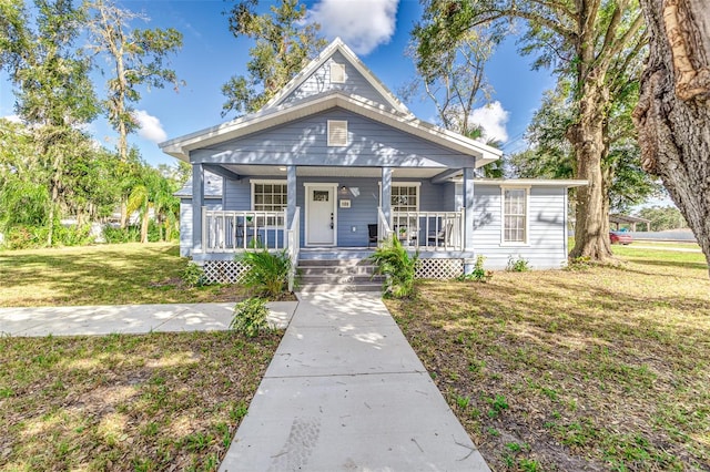 bungalow-style house featuring a front lawn and covered porch