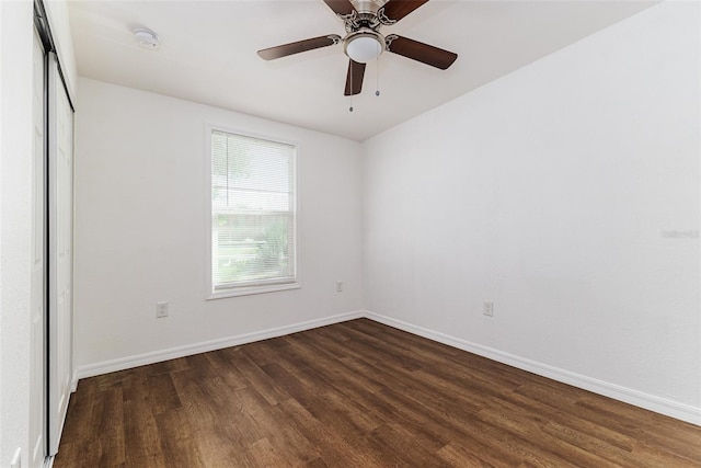 spare room with ceiling fan and dark hardwood / wood-style floors