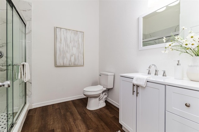 bathroom with toilet, an enclosed shower, vanity, and hardwood / wood-style floors