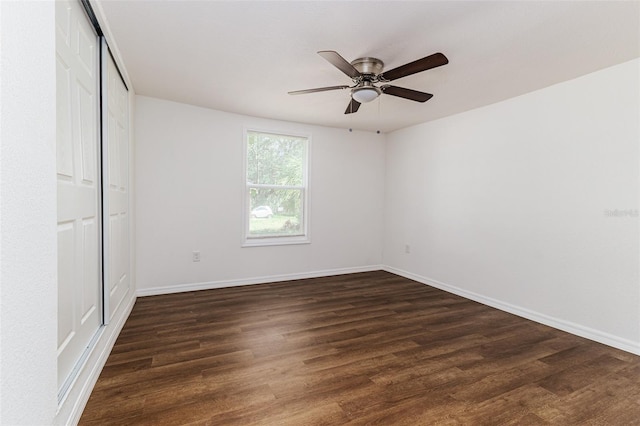 unfurnished bedroom featuring ceiling fan and dark hardwood / wood-style flooring