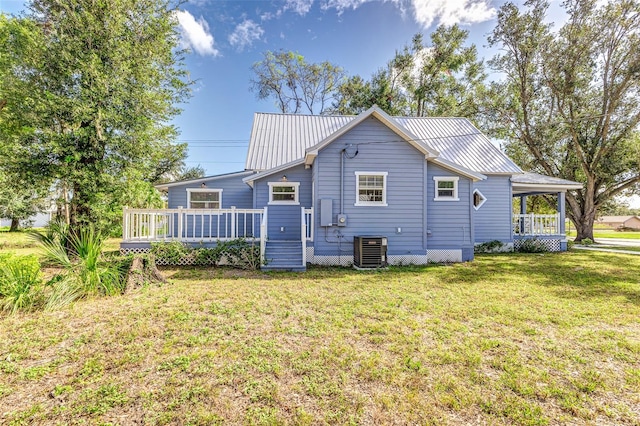 back of house with cooling unit, a yard, and a wooden deck