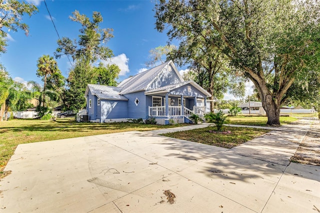 view of front of house with a front yard and covered porch