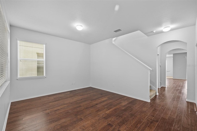 unfurnished room with dark hardwood / wood-style flooring