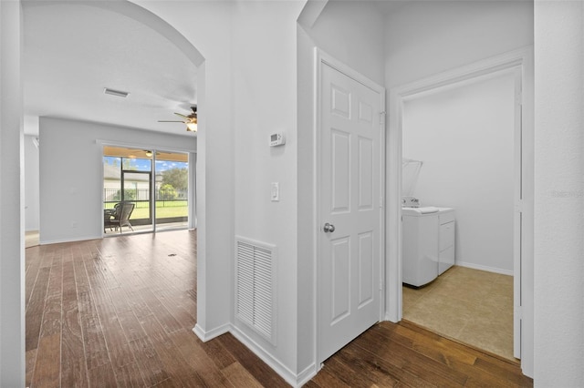 corridor featuring washing machine and clothes dryer and dark hardwood / wood-style floors