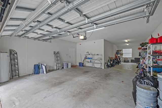 garage with electric water heater and a garage door opener