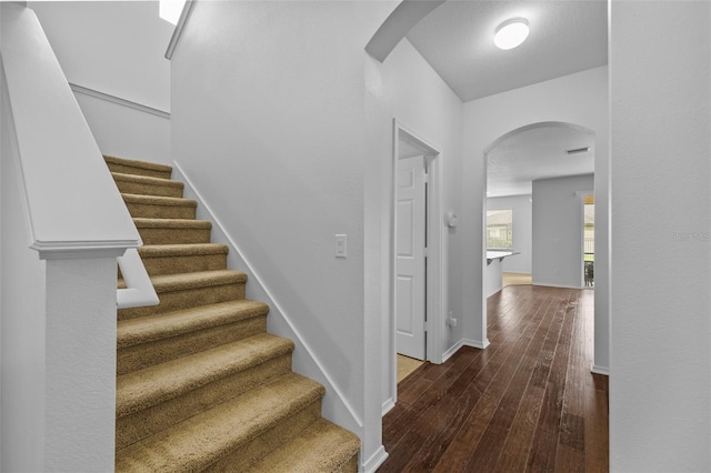 stairs with hardwood / wood-style floors