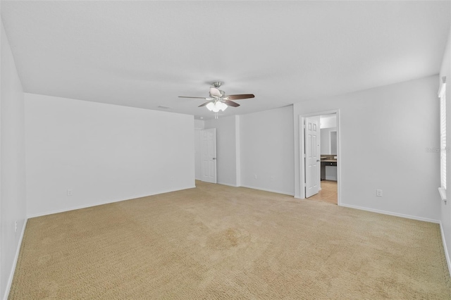 empty room with light colored carpet and ceiling fan