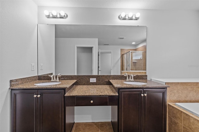 bathroom with vanity, tile patterned floors, and plus walk in shower