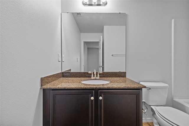 bathroom featuring toilet and vanity