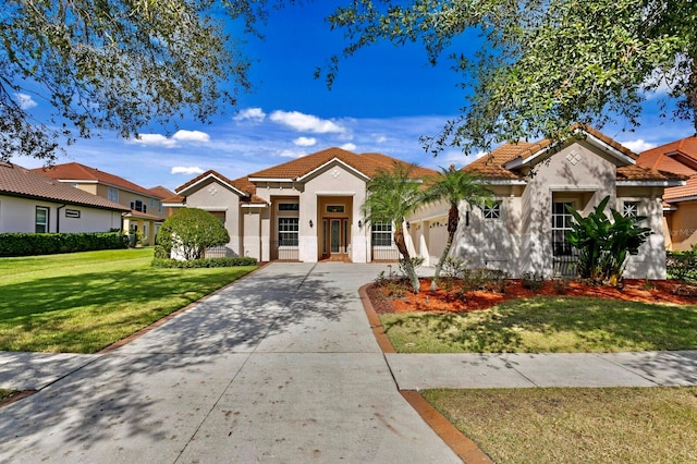 mediterranean / spanish house featuring a front lawn and a garage