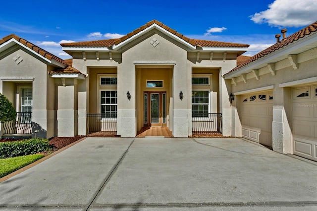 mediterranean / spanish home with a garage