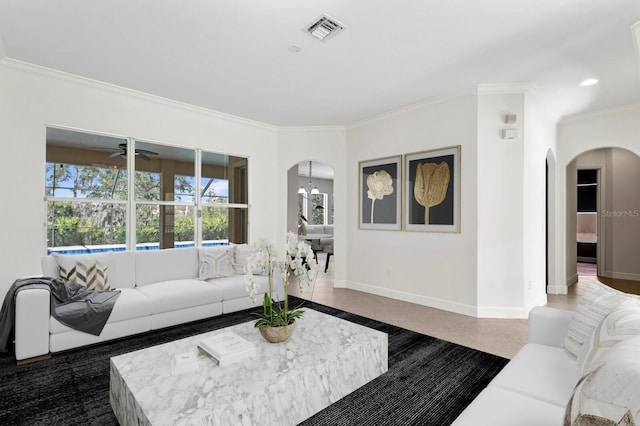 living room with tile patterned floors, ceiling fan, and ornamental molding