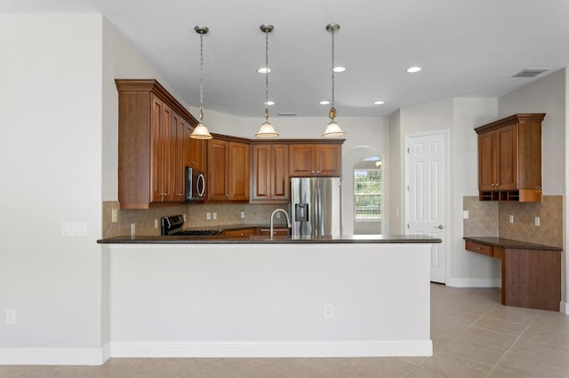 kitchen featuring appliances with stainless steel finishes, tasteful backsplash, sink, light tile patterned floors, and pendant lighting