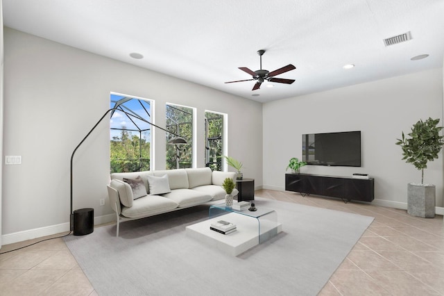 living room featuring ceiling fan and light tile patterned flooring