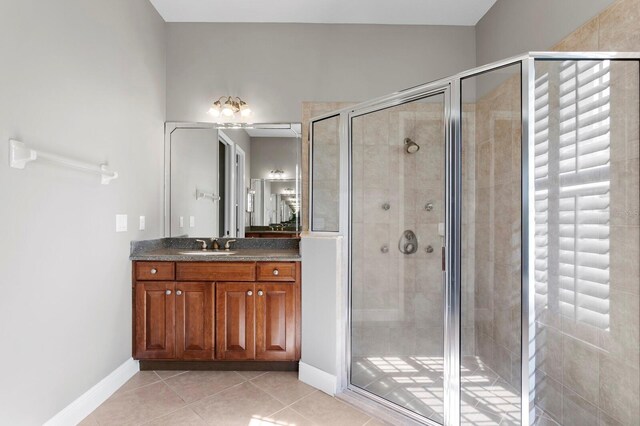 bathroom with vanity, tile patterned floors, and a shower with shower door