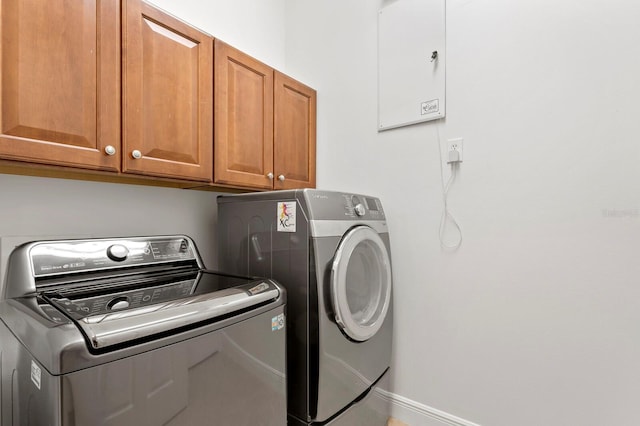 washroom featuring cabinets and washing machine and clothes dryer