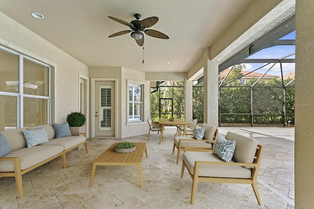 sunroom featuring ceiling fan