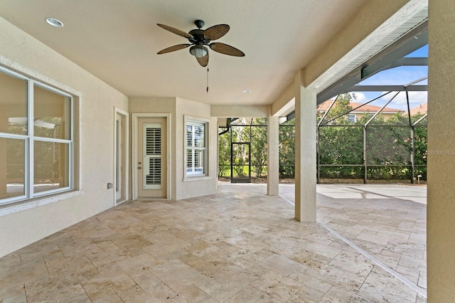 view of patio with glass enclosure and ceiling fan