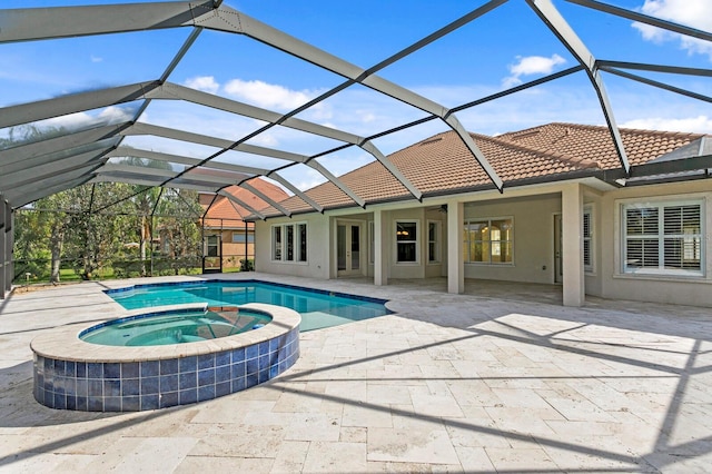 view of pool with glass enclosure, ceiling fan, a patio area, and an in ground hot tub