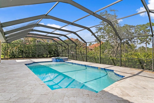 view of swimming pool with glass enclosure, an in ground hot tub, and a patio