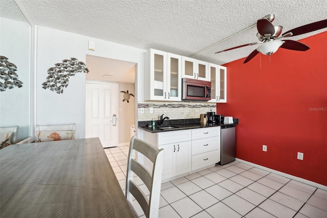 kitchen featuring white cabinets, a textured ceiling, and appliances with stainless steel finishes