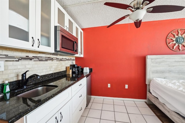 kitchen featuring white cabinetry, sink, tasteful backsplash, a textured ceiling, and stainless steel appliances