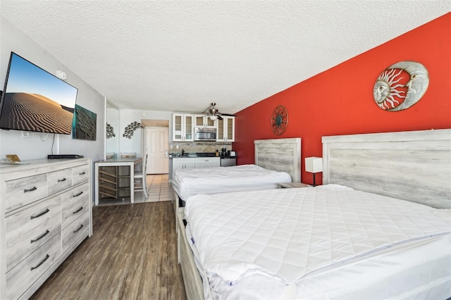 bedroom featuring dark hardwood / wood-style flooring and a textured ceiling