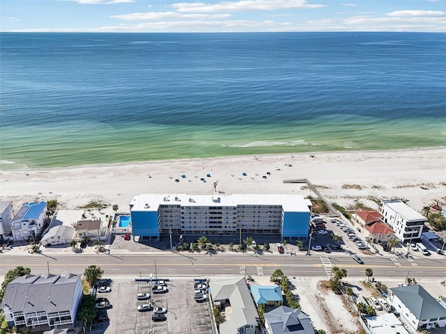 birds eye view of property featuring a water view and a beach view