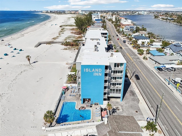 bird's eye view with a water view and a beach view