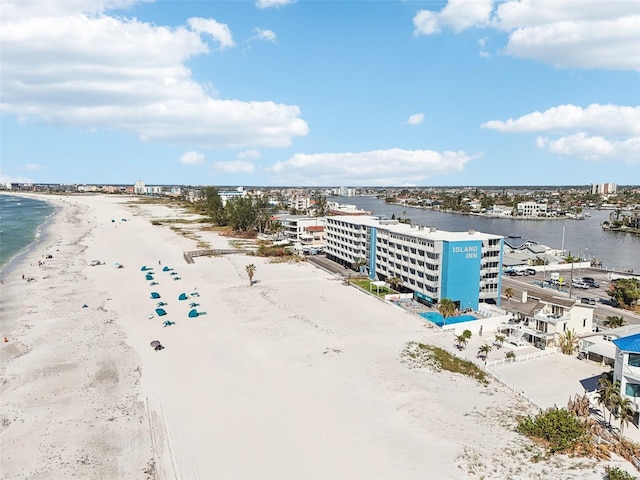 drone / aerial view featuring a water view and a view of the beach