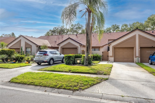 ranch-style home featuring a garage and a front yard