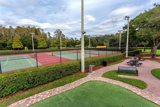 view of tennis court featuring fence