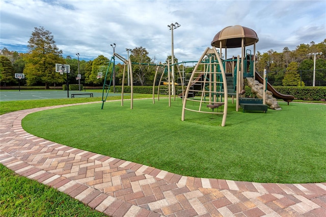 community jungle gym featuring a yard and community basketball court