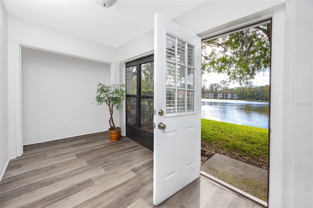 interior space featuring a water view and wood finished floors