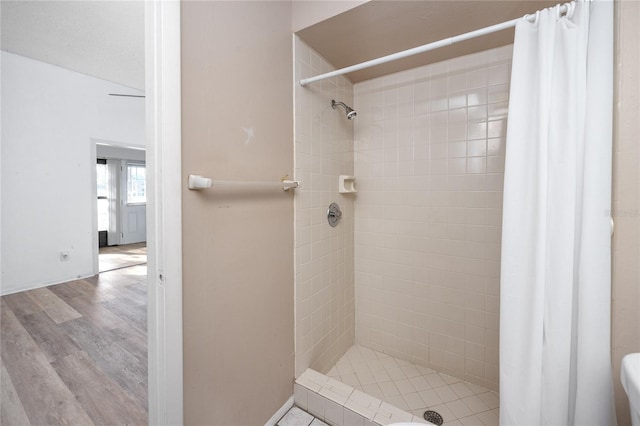 bathroom featuring a stall shower and wood finished floors