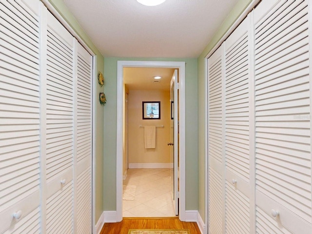 hallway with light hardwood / wood-style floors