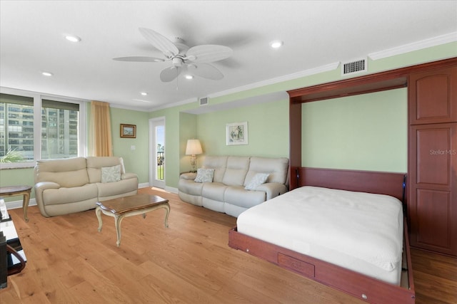 living room featuring crown molding, ceiling fan, and light wood-type flooring