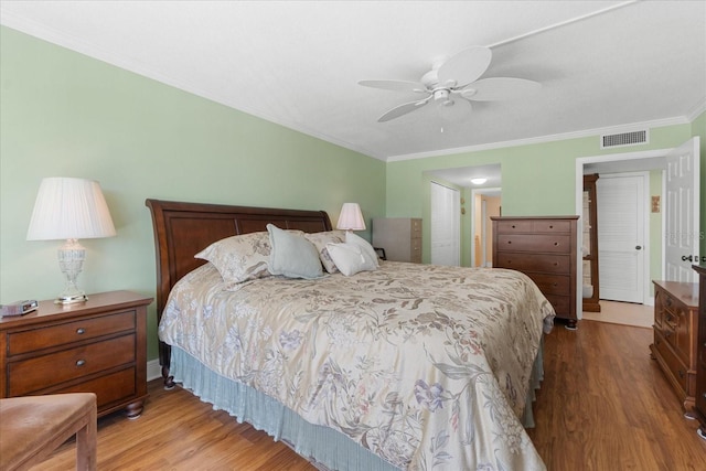 bedroom featuring wood-type flooring, ceiling fan, and crown molding