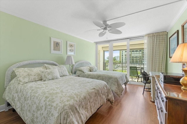 bedroom featuring crown molding, expansive windows, access to exterior, and dark hardwood / wood-style flooring