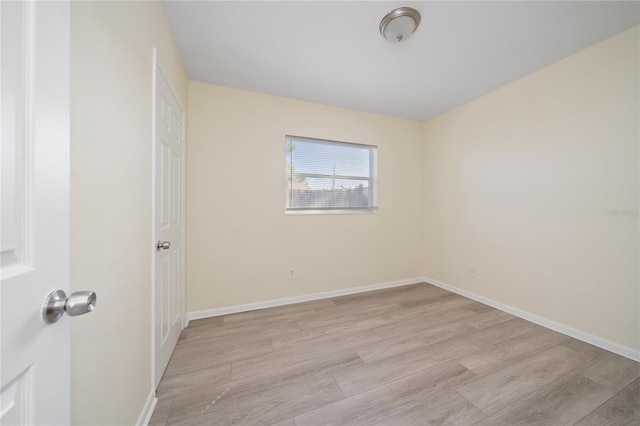 unfurnished room with light wood-type flooring