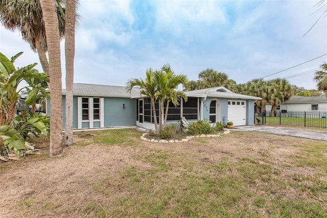 single story home with a garage and a front lawn