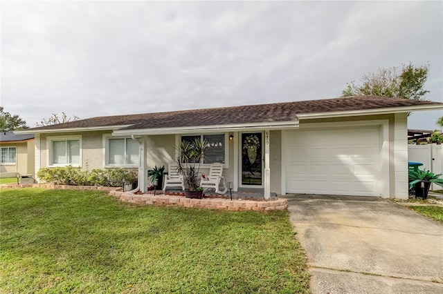 single story home featuring a garage and a front lawn